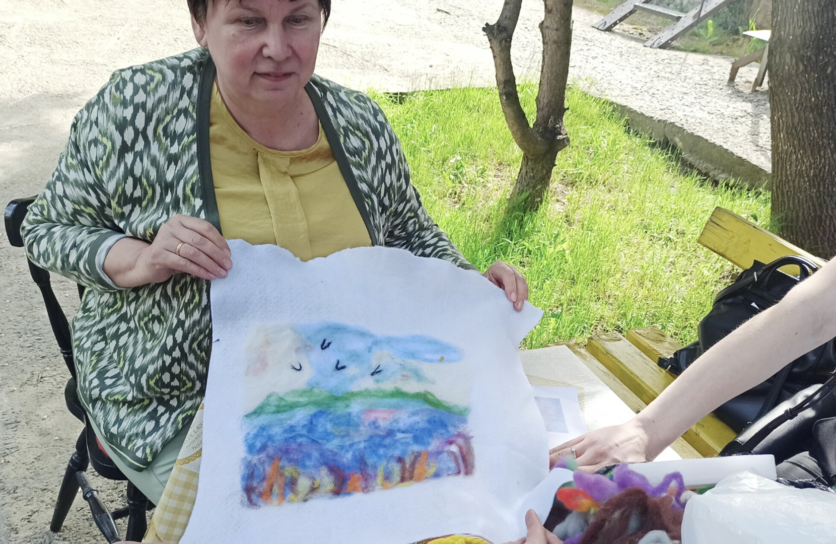 painting-on-clothing Woman holding a painting on clothing.
